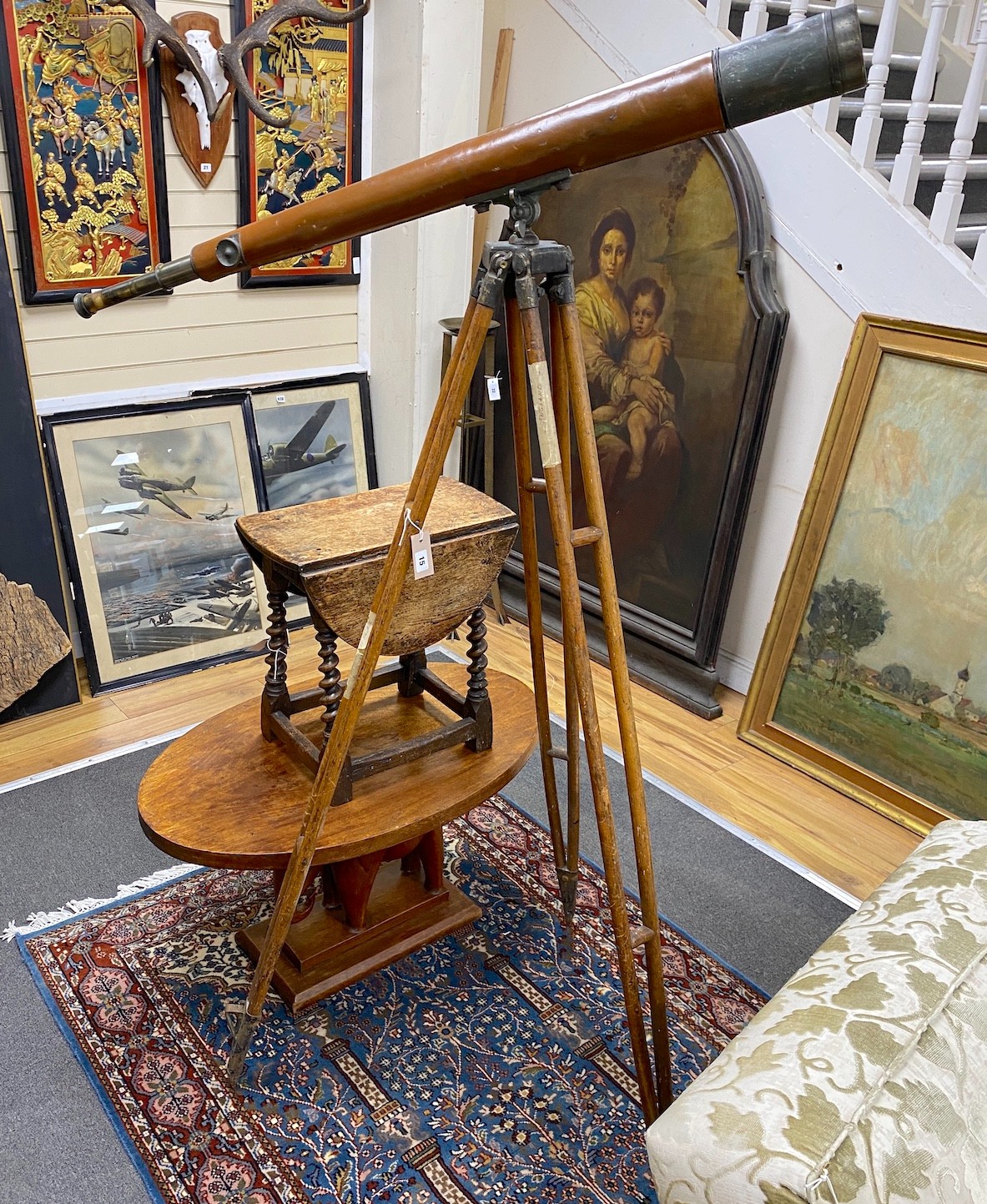 A Broadhurst Clarkson telescope with leather outer cover on folding tripod stand